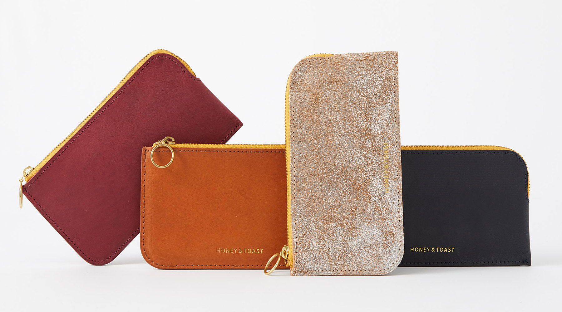 Honey and Toast leather purses in tan, navy, pink and silver