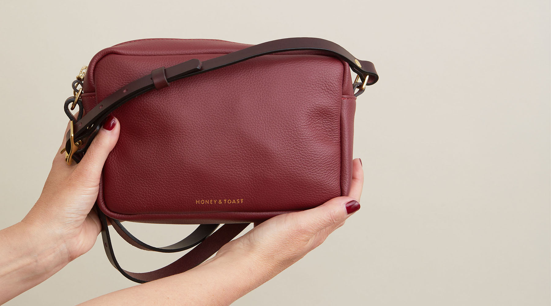 Woman wearing 3 different Honey and Toast bags, a dark red clutch, half moon and slouchy leather shoulder bag