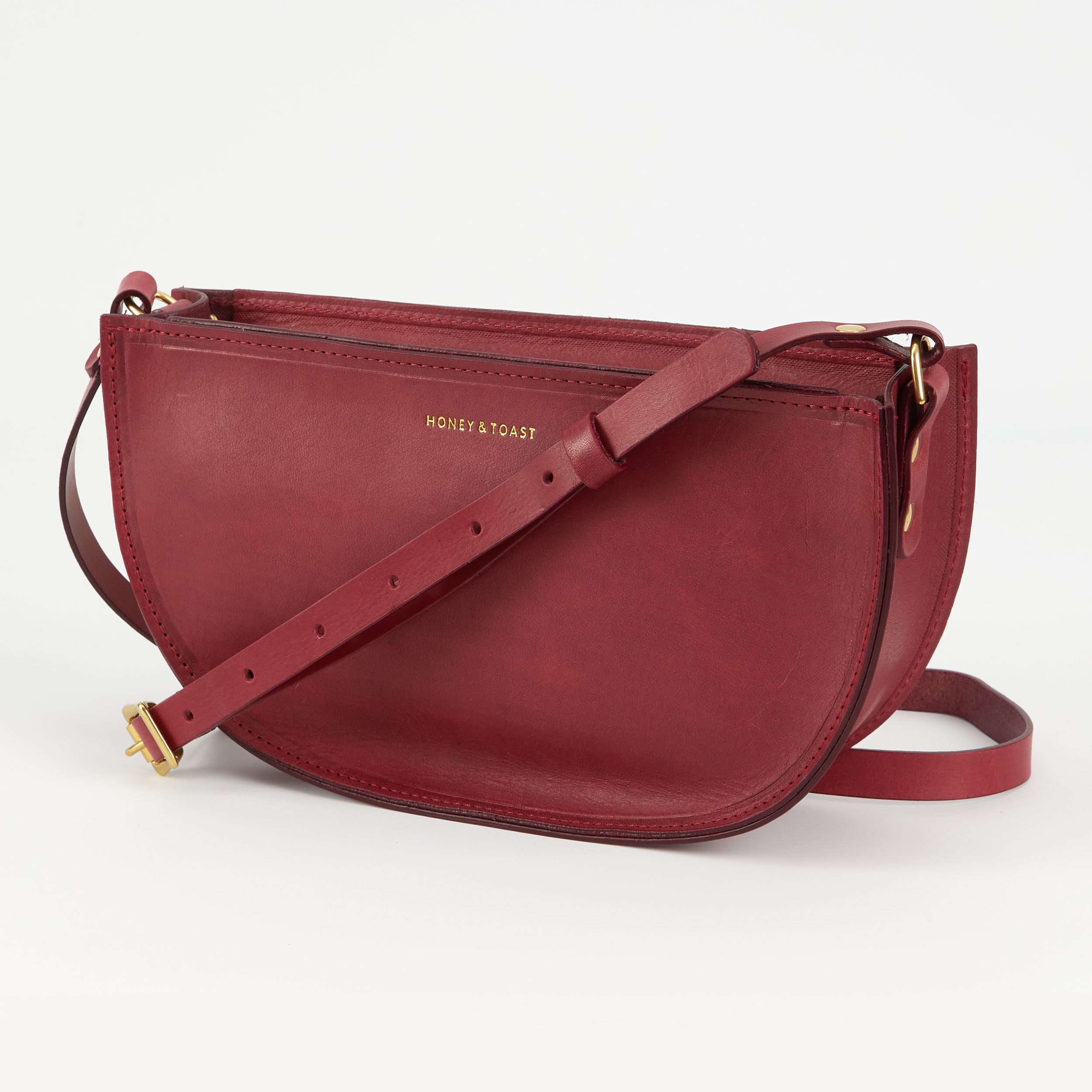 https://www.honeyandtoast.co.uk women's leather handbag Large half moon bag raspberry