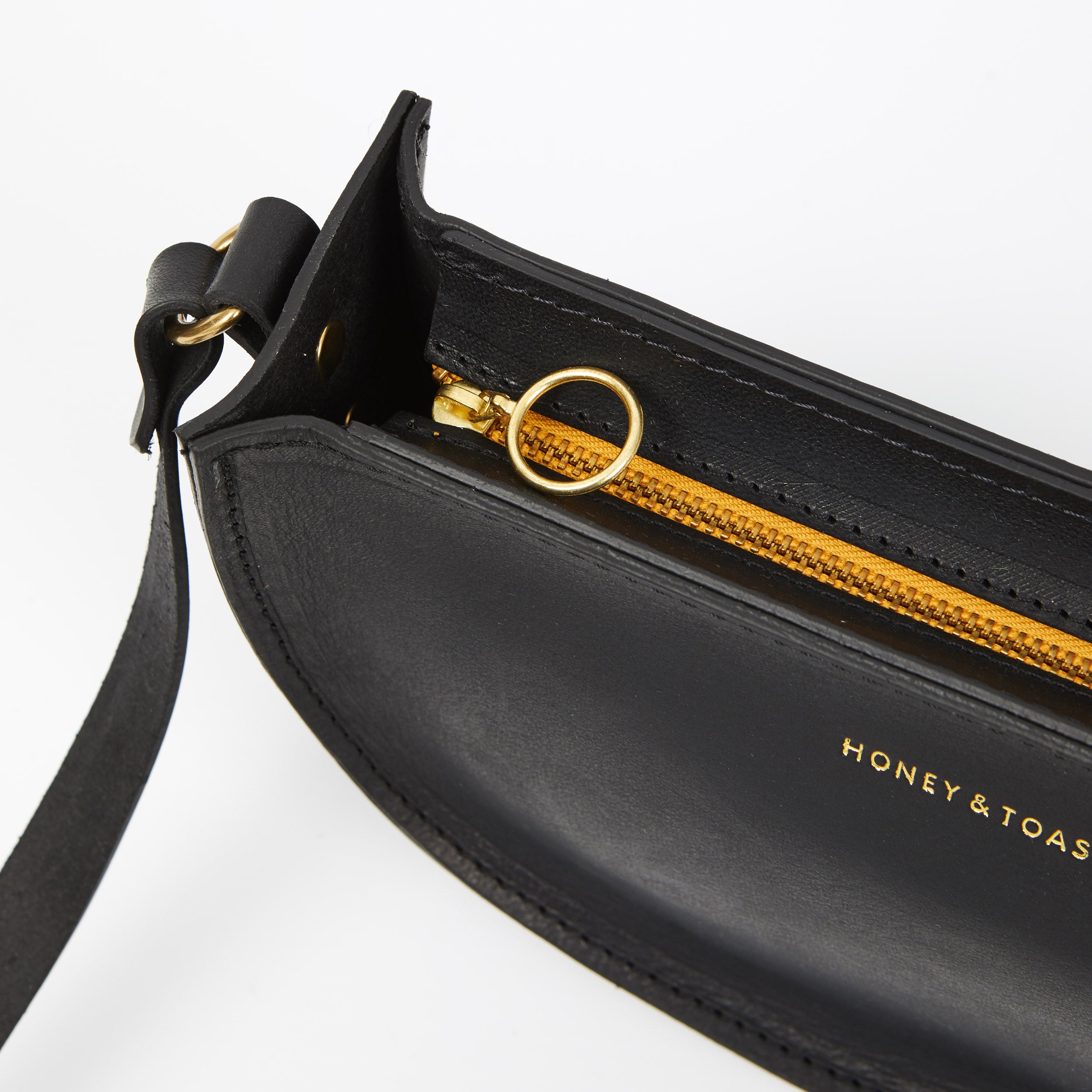 https://www.honeyandtoast.co.uk Half moon bag black