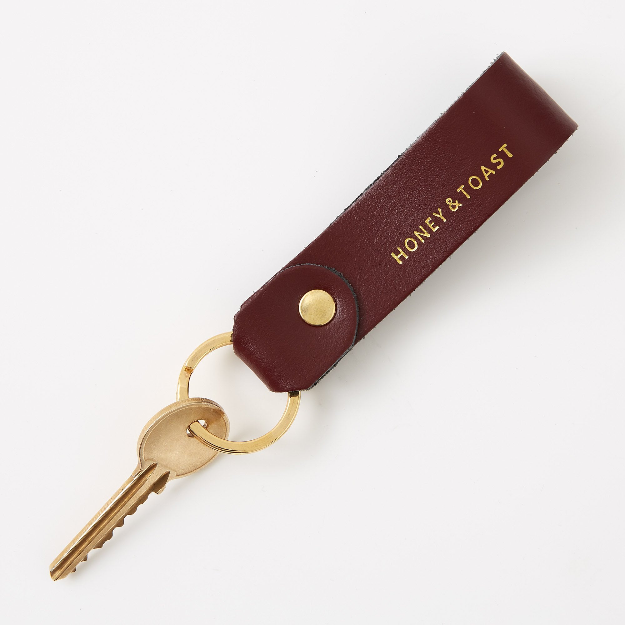 https://www.honeyandtoast.co.uk Leather loop keyring dark red