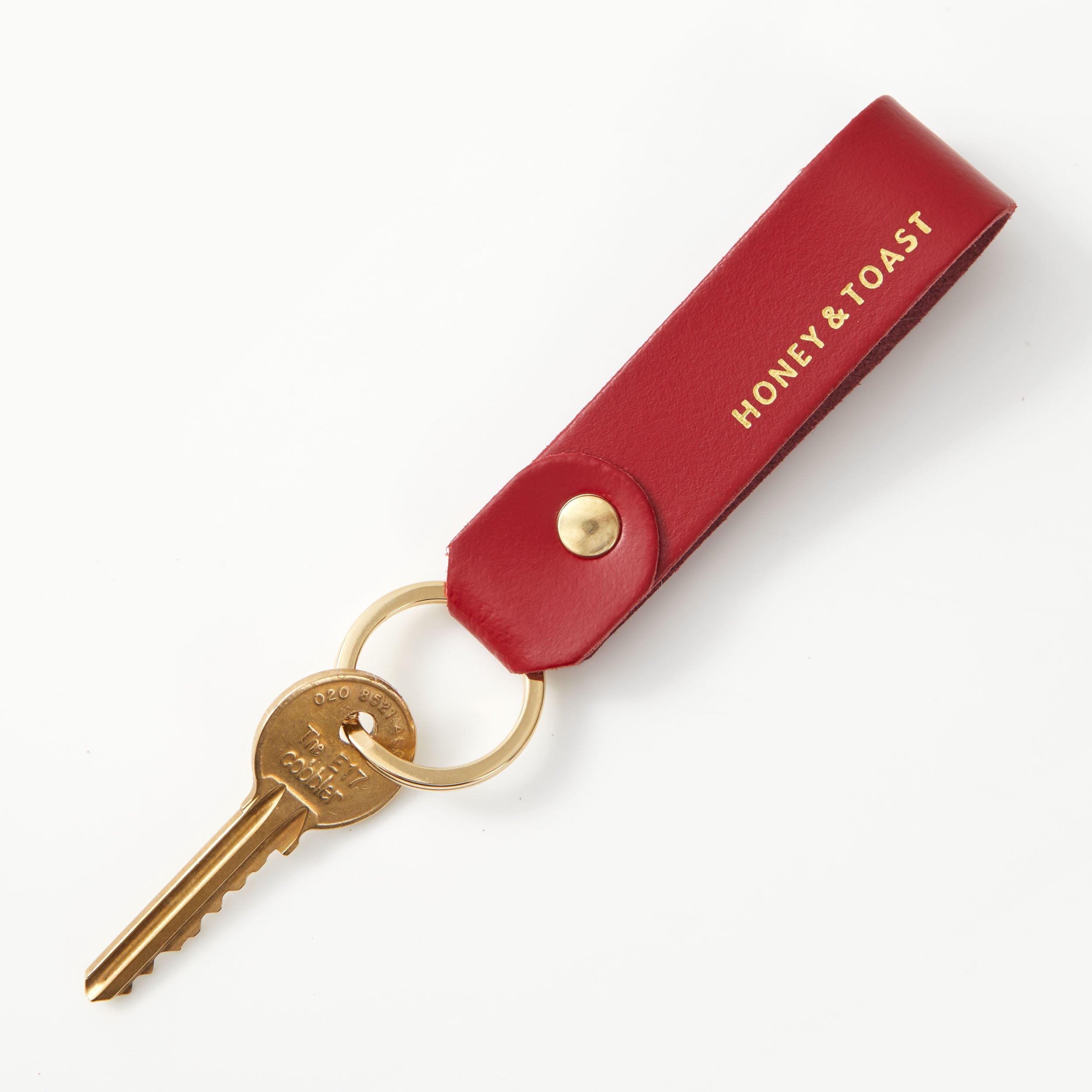 https://www.honeyandtoast.co.uk Leather loop keyring red