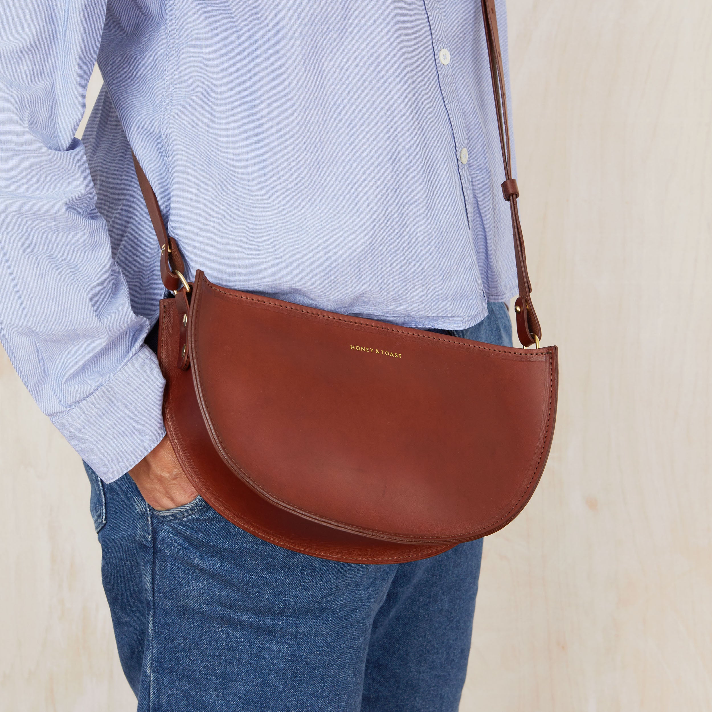 Half moon shaped brown leather handbag