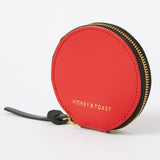 https://www.honeyandtoast.co.uk Cora round zipped coin purse red