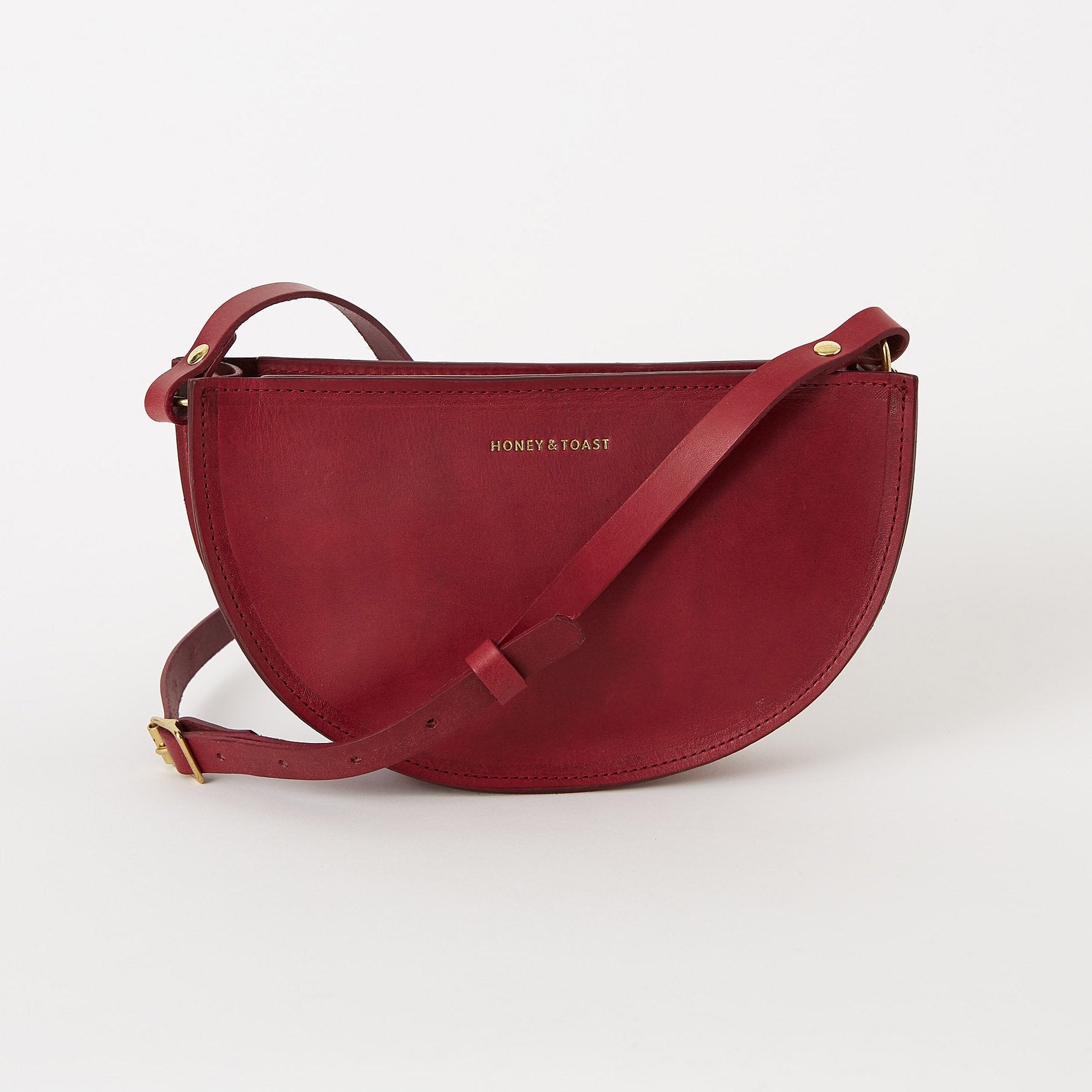 https://www.honeyandtoast.co.uk Half moon bag raspberry pink