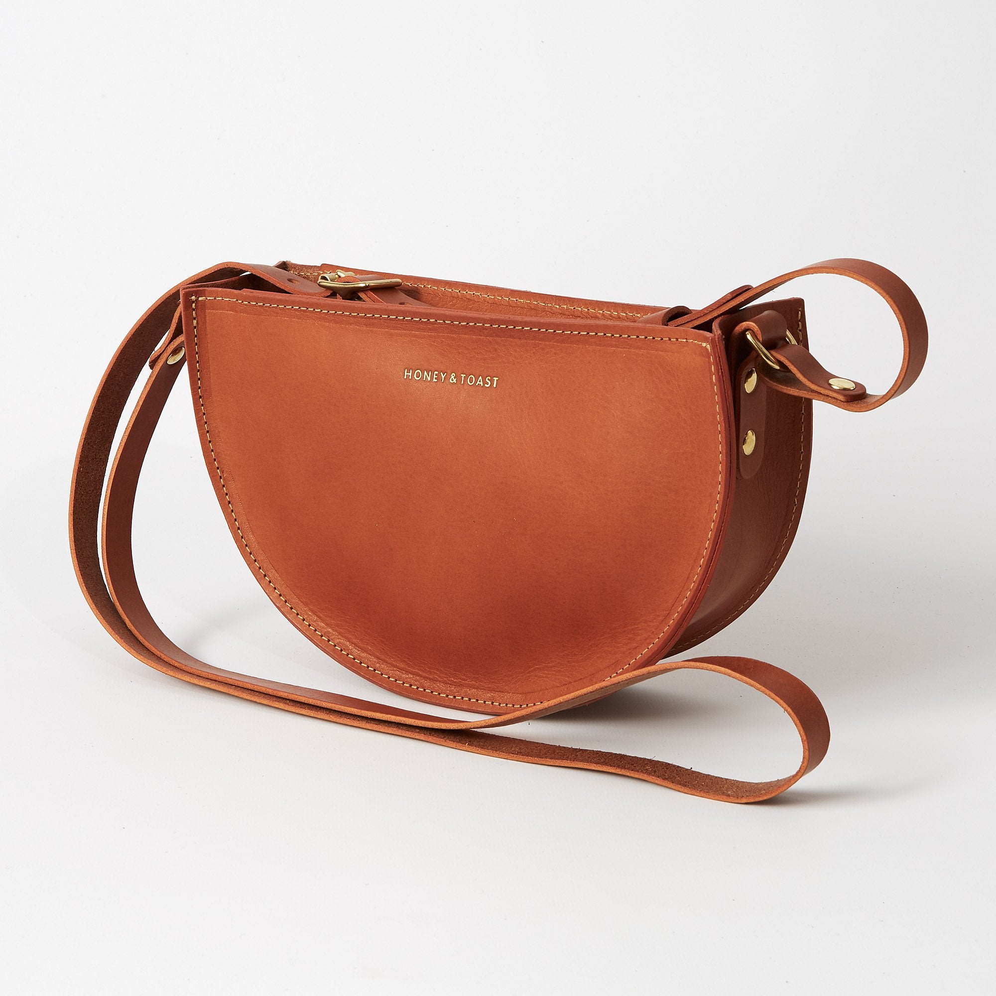 https://www.honeyandtoast.co.uk Half moon bag tan