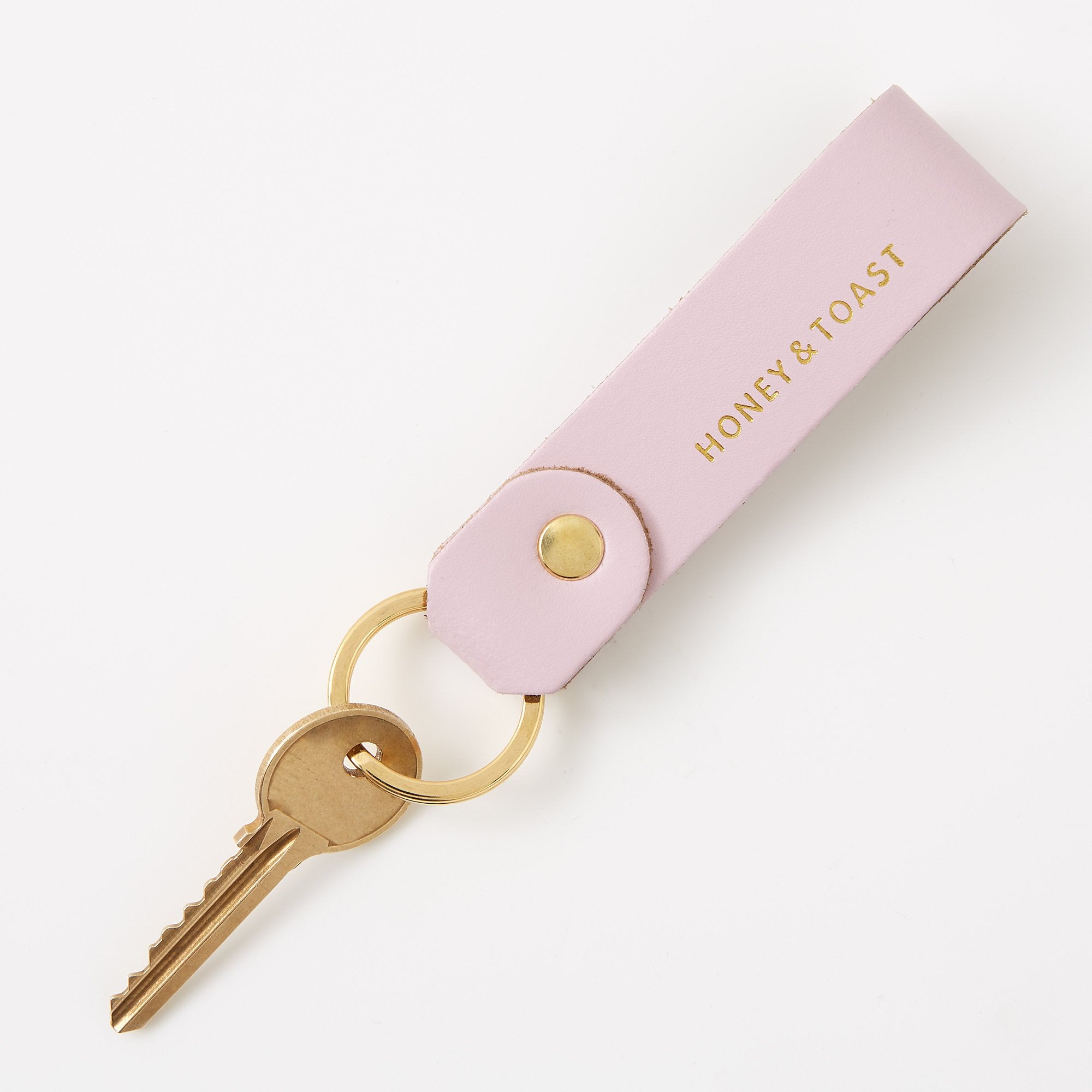 https://www.honeyandtoast.co.uk Leather loop keyring calamine pink