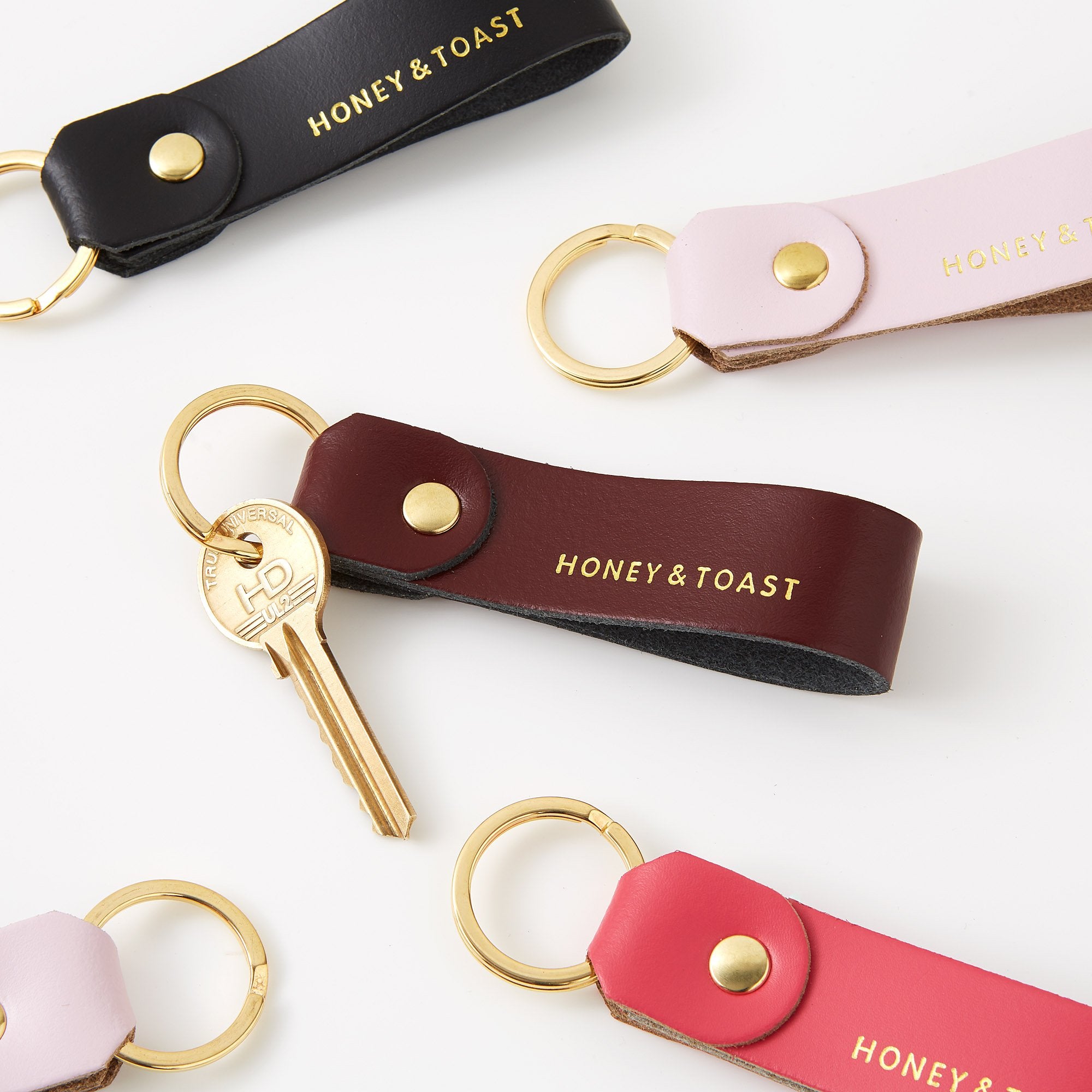 https://www.honeyandtoast.co.uk Leather loop keyring calamine pink